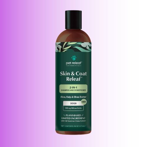 A bottle of pet releaf Skin & Coat Releaf 2-in-1 shampoo and conditioner for dogs, shown against a purple-to-white gradient background.