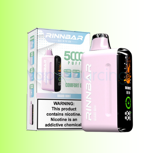 A Rinnbar disposable vape device in light pink and black shown next to its retail packaging box on a light green gradient background. The box features the Rinnbar brand name, 'Grand Comfort' variant, '5000 PUFFS' text, and a prominent nicotine warning label.