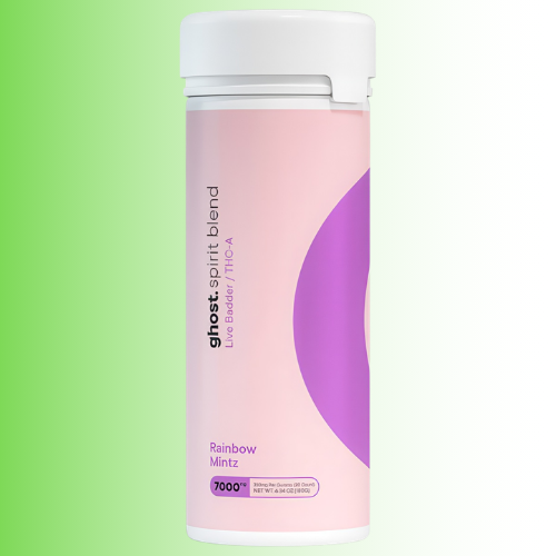 A cylindrical canister of Ghost Spirit Blend THC butter in Rainbow Mintz flavor, featuring a pink and purple label with a white cap, set against a green-to-white gradient background.