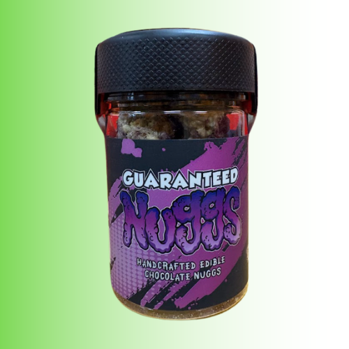 A jar of 'Guaranteed Nuggs' handcrafted edible chocolate nuggs, featuring a black textured lid and a black and purple label, set against a green-to-white gradient background.