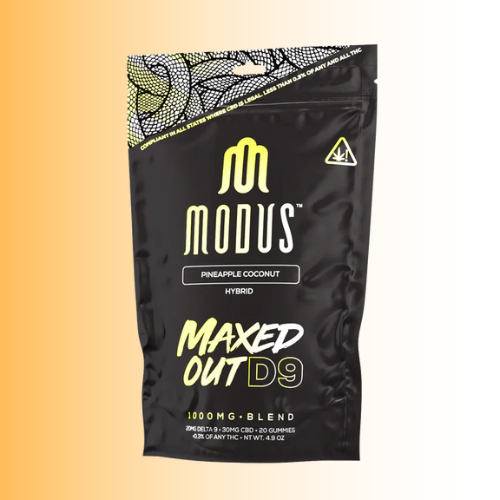 Black packaging of Modus Maxed Out D9 Pineapple Coconut flavor with yellow text on a gradient background
