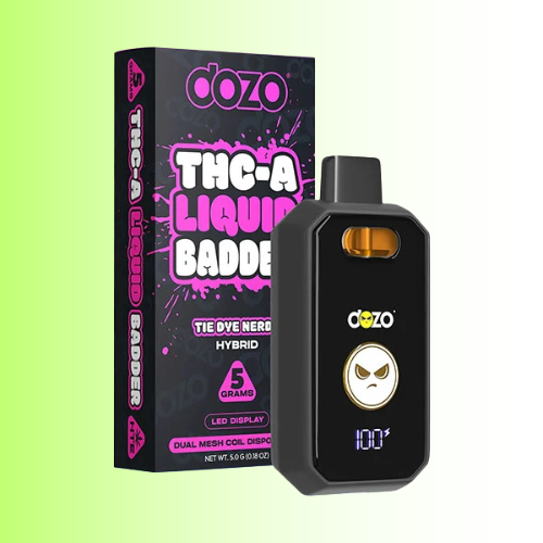 A Dozo THC-A Liquid Badder The Dye Nerds hybrid vape device in black with a gold and white logo, shown next to its black and pink retail box on a light green gradient background