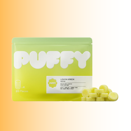 Puffy Lemon Wreck gum packaging in a bright yellow-green pouch with large white PUFFY branding, shown on a warm gradient background with several pale yellow round gummies placed in front.