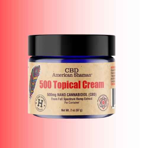 A jar of American Shaman CBD 500 Topical Cream, featuring a black lid and a beige label with red and black text, set against a red-to-white gradient background.