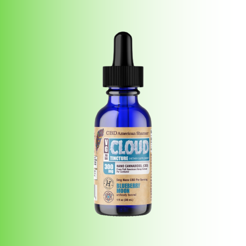 A 1 fl oz cobalt blue glass dropper bottle of CBD tincture with a black cap and a tan label, shown against a green-to-white gradient background. The label reads 'CLOUD TINCTURE' and 'BLUEBERRY MOON'.